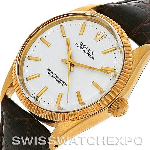 This image shows a close-up, angled view of the Rolex Oyster Perpetual Men
s Yellow Gold White Dial Men
s Yellow Gold White Dial watch, highlighting its dial, hands, bezel, and crown.
