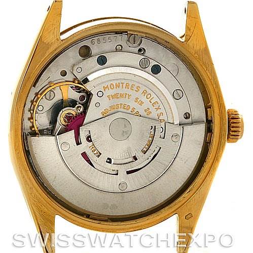 This image shows the back view of a Rolex Oyster Perpetual Men
s Yellow Gold White Dial Men
s Yellow Gold White Dial watch, highlighting its movement and inner workings.