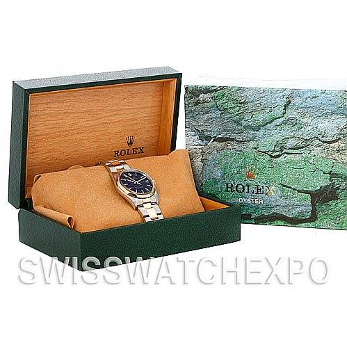 The image shows a Rolex Oyster Perpetual 14203 Men's Steel and Gold (two tone) Black Dial 14203 Men's Steel and Gold (two tone) Black Dial watch in an open box with its packaging.