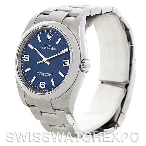 The image shows a Rolex Oyster Perpetual 116000BLASO Men's Stainless Steel Blue Dial 116000BLASO Men's Stainless Steel Blue Dial watch at an angled view, highlighting the face, bezel, crown, and bracelet.