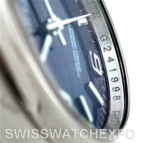 This close-up angle of the Rolex Oyster Perpetual 116000BLASO Men's Stainless Steel Blue Dial 116000BLASO Men's Stainless Steel Blue Dial watch shows part of the dial, hour markers, and the bezel with serial numbers.