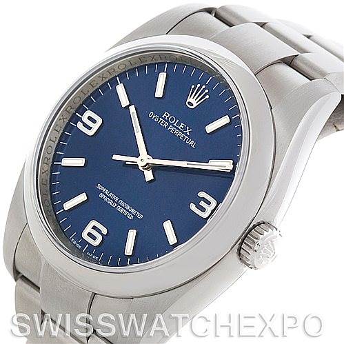 This image shows a Rolex Oyster Perpetual 116000BLASO Men's Stainless Steel Blue Dial 116000BLASO Men's Stainless Steel Blue Dial watch at a slight angle, highlighting the dial, bezel, crown, and part of the bracelet.