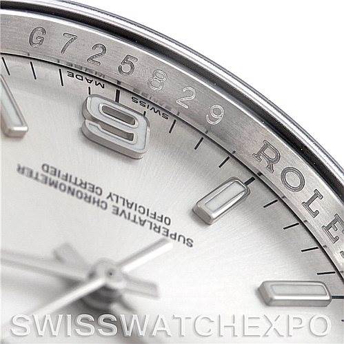 This image shows a close-up angle of the dial and bezel of a Rolex Oyster Perpetual 116000 Men
s Stainless Steel Silver Dial 116000 Men
s Stainless Steel Silver Dial watch, highlighting numerals and text.