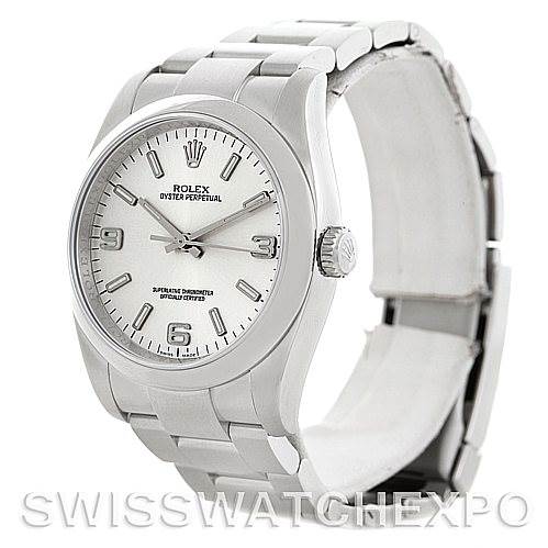 The image shows a Rolex Oyster Perpetual 116000 Men
s Stainless Steel Silver Dial 116000 Men
s Stainless Steel Silver Dial watch at an angle, displaying the dial, crown, and bracelet.