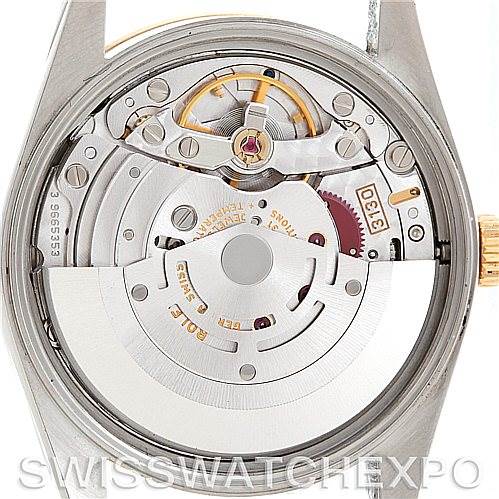 The image shows the movement mechanism of a Rolex Oyster Perpetual 14203 Men's Steel and Gold (two tone) Blue Dial 14203 Men's Steel and Gold (two tone) Blue Dial watch from the back, highlighting the internal components.