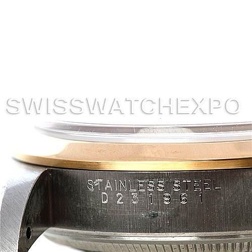 This is an image of the side view of a stainless steel Rolex Oyster Perpetual 14203 Men's Steel and Gold (two tone) Blue Dial 14203 Men's Steel and Gold (two tone) Blue Dial watch, focusing on the engraved serial number and bezel.