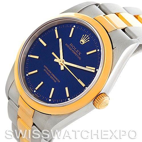 The image shows a Rolex Oyster Perpetual 14203 Men's Steel and Gold (two tone) Blue Dial 14203 Men's Steel and Gold (two tone) Blue Dial watch at an angle, highlighting the face, crown, and part of the band.