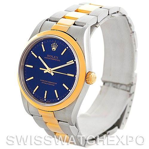 This image shows a side view of a Rolex Oyster Perpetual 14203 Men's Steel and Gold (two tone) Blue Dial 14203 Men's Steel and Gold (two tone) Blue Dial, highlighting its blue dial, gold bezel, and two-tone metal bracelet.