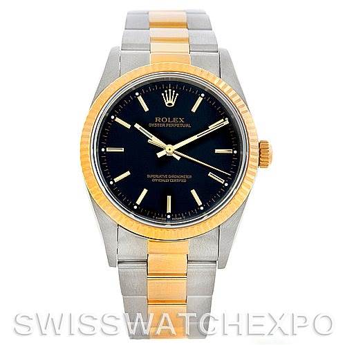 This image shows a Rolex Oyster Perpetual 14233 Men's Steel and Gold (two tone) Black Dial 14233 Men's Steel and Gold (two tone) Black Dial watch from a frontal angle, highlighting its black dial, gold bezel, and two-tone metal bracelet.