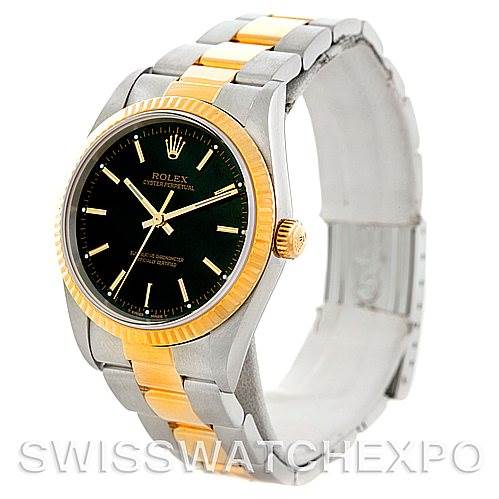 This image shows a Rolex Oyster Perpetual 14233 Men's Steel and Gold (two tone) Black Dial 14233 Men's Steel and Gold (two tone) Black Dial watch angled to display its face, gold bezel, and two-tone metal bracelet.