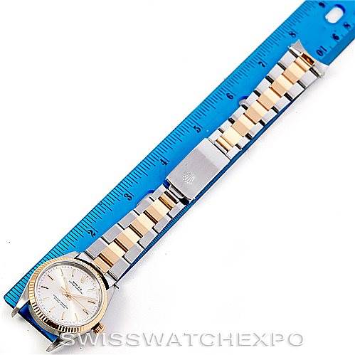 The Rolex Oyster Perpetual 14233 Men's Steel and Gold (two tone) Silver Dial 14233 Men's Steel and Gold (two tone) Silver Dial watch is shown from a top-down angle, displaying the face and the full bracelet alongside a ruler for scale.