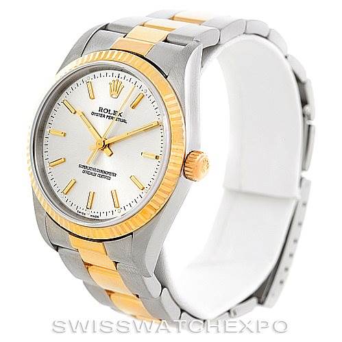 The image shows a Rolex Oyster Perpetual 14233 Men's Steel and Gold (two tone) Silver Dial 14233 Men's Steel and Gold (two tone) Silver Dial watch, captured at a three-quarter angle, highlighting its dial, bezel, and bracelet.