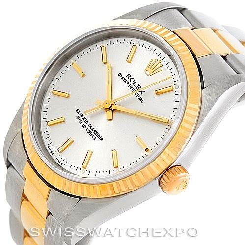 The image shows a Rolex Oyster Perpetual 14233 Men's Steel and Gold (two tone) Silver Dial 14233 Men's Steel and Gold (two tone) Silver Dial watch at a three-quarter angle, highlighting its gold and silver case, dial, and bracelet.