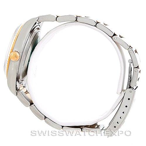 This is a side view of a Rolex Oyster Perpetual 14233 Men's Steel and Gold (two tone) Silver Dial 14233 Men's Steel and Gold (two tone) Silver Dial watch, showing its bracelet, crown, and case.