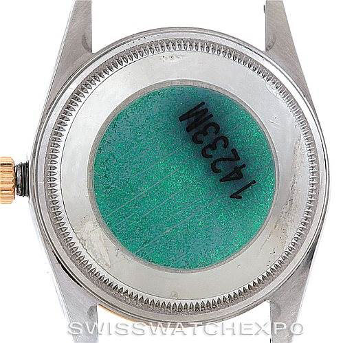 This image shows the back case and crown of a Rolex Oyster Perpetual 14233 Men's Steel and Gold (two tone) Silver Dial 14233 Men's Steel and Gold (two tone) Silver Dial watch, including the holographic sticker with numbers.