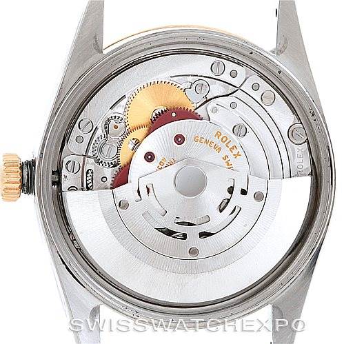 This image shows the back view of a Rolex Oyster Perpetual 14233 Men's Steel and Gold (two tone) Silver Dial 14233 Men's Steel and Gold (two tone) Silver Dial watch, highlighting its internal mechanism and intricate components.