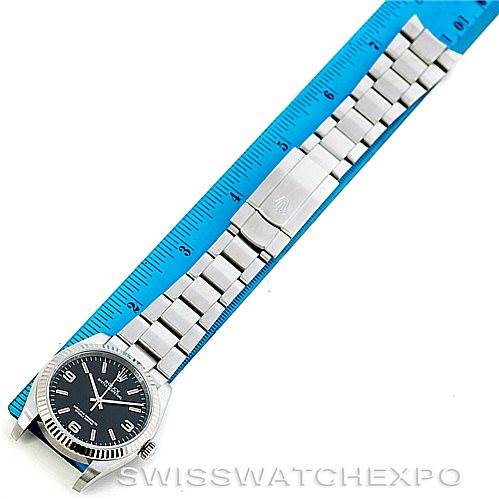 The image shows a full view of the Rolex Oyster Perpetual 116034 Men's Stainless Steel Black Dial 116034 Men's Stainless Steel Black Dial watch with its bracelet laid flat next to a ruler for scale.