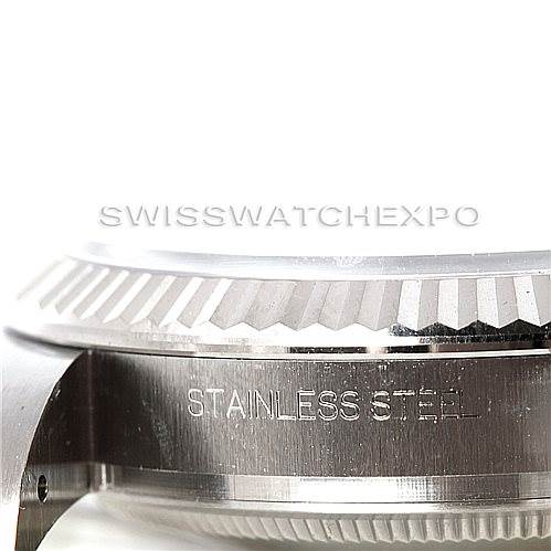 This image shows a close-up side view of the bezel and case, labeled "STAINLESS STEEL," of a Rolex Oyster Perpetual 116034 Men's Stainless Steel Black Dial 116034 Men's Stainless Steel Black Dial watch.
