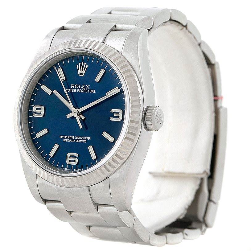 The image shows a Rolex Oyster Perpetual 116034 Men's Stainless Steel Blue Dial 116034 Men's Stainless Steel Blue Dial watch from an angled perspective, highlighting the face, bezel, crown, and bracelet.