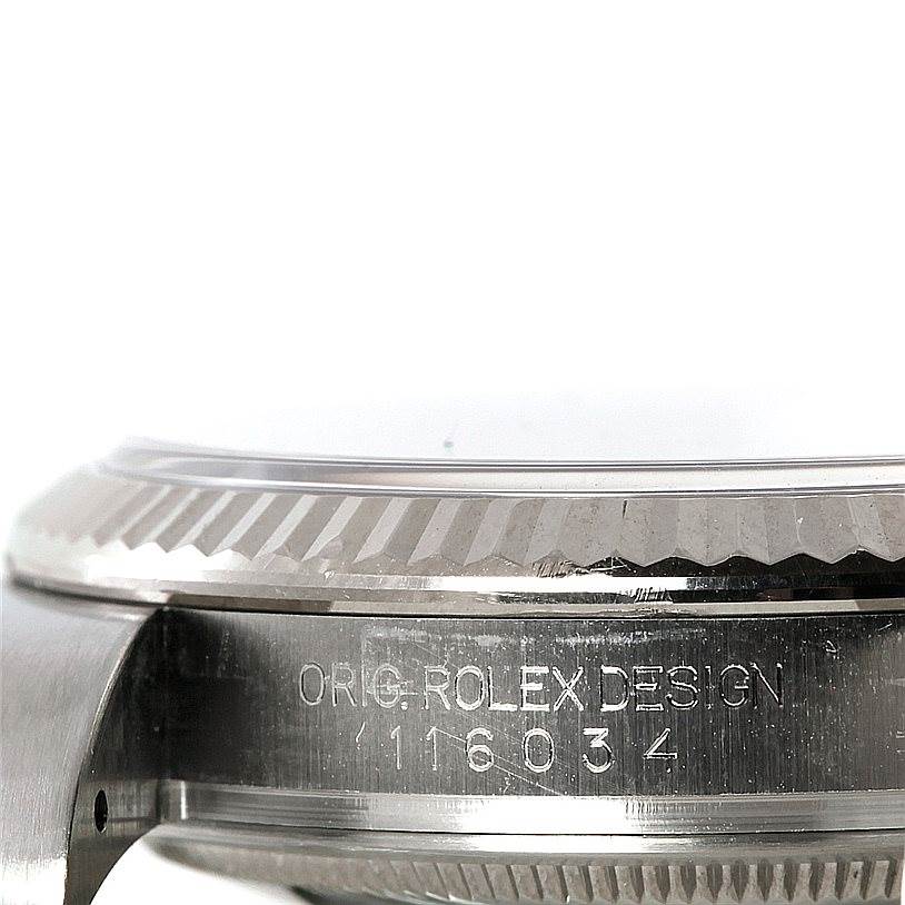 The image shows a close-up side view of the Rolex Oyster Perpetual 116034 Men's Stainless Steel Blue Dial 116034 Men's Stainless Steel Blue Dial watch, highlighting the bezel and design engraving.