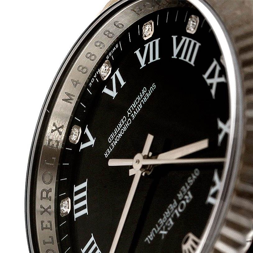 The image shows a close-up view of the dial and bezel of the Rolex Oyster Perpetual 116034 Men
s Stainless Steel Black Dial 116034 Men
s Stainless Steel Black Dial watch, highlighting the Roman numerals and bezel engraving.
