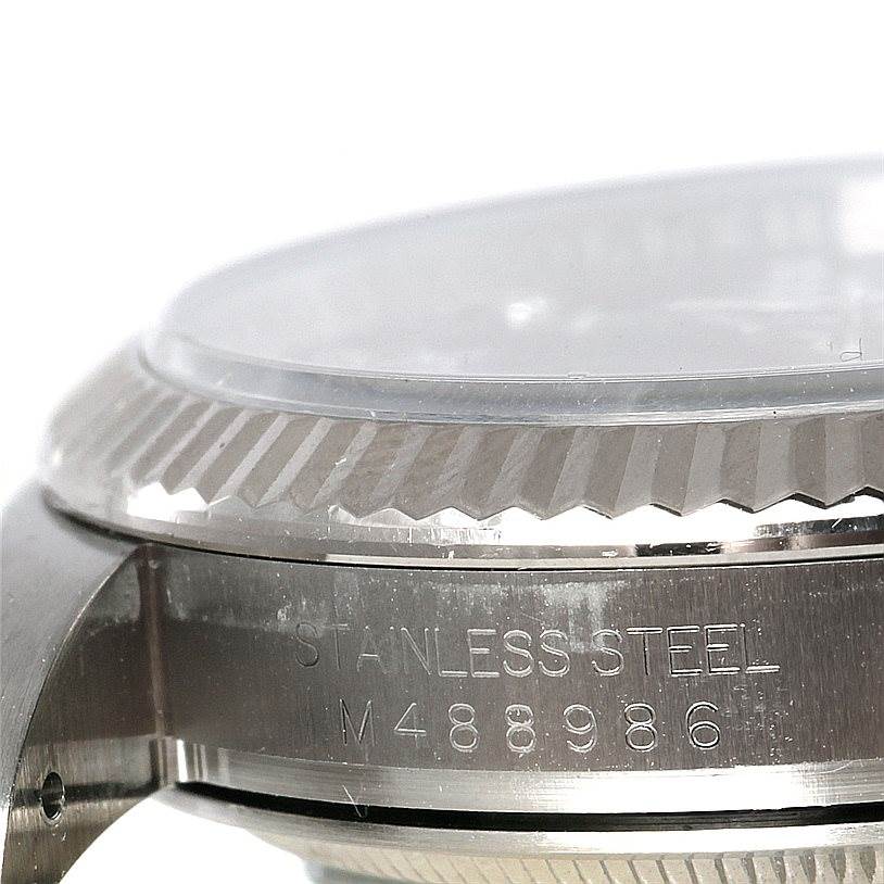 The image shows the side view of a Rolex Oyster Perpetual 116034 Men
s Stainless Steel Black Dial 116034 Men
s Stainless Steel Black Dial watch, highlighting the stainless steel case and part of the bezel.