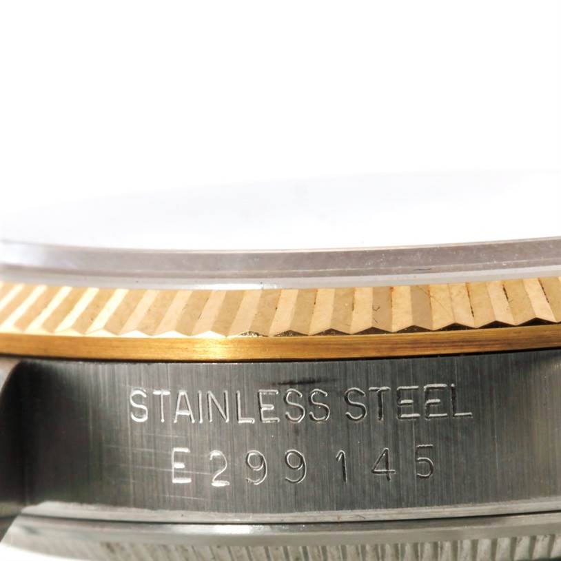 The image shows a close-up side view of the stainless steel and gold bezel, and part of the case with an engraving on a Rolex Oyster Perpetual 14233 Men's Steel and Gold (two tone) Silver Dial 14233 Men's Steel and Gold (two tone) Silver Dial watch.