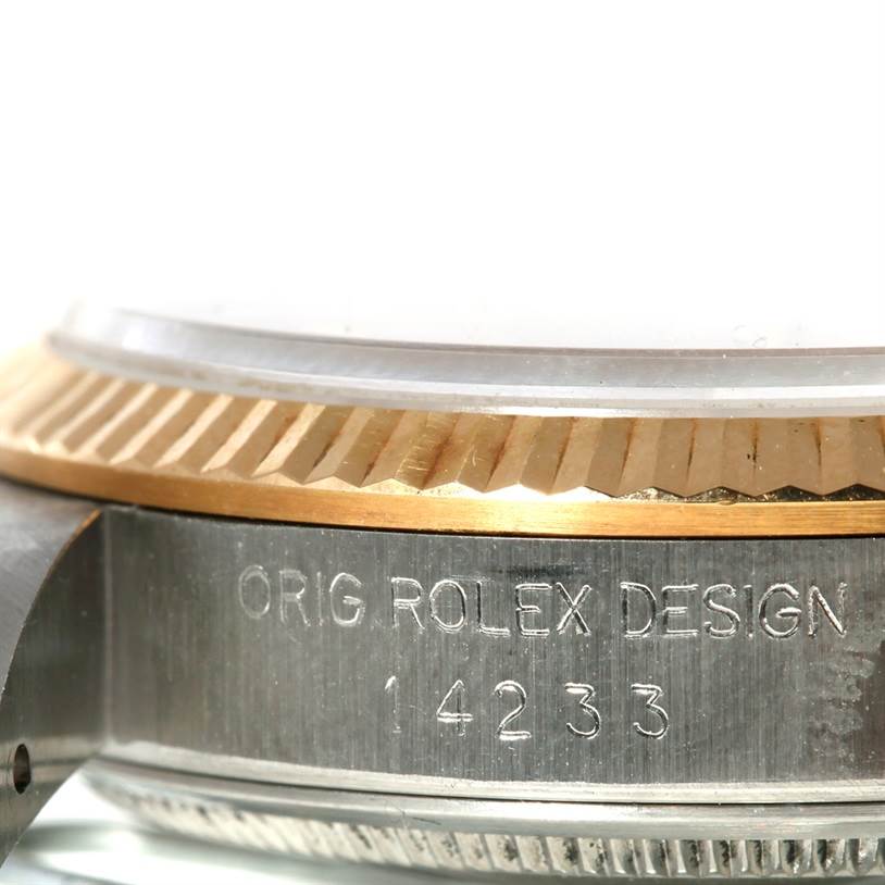 This image shows the side angle of a Rolex Oyster Perpetual 14233 Men's Steel and Gold (two tone) Silver Dial 14233 Men's Steel and Gold (two tone) Silver Dial watch, focusing on the bezel and the engraved model number 14233.