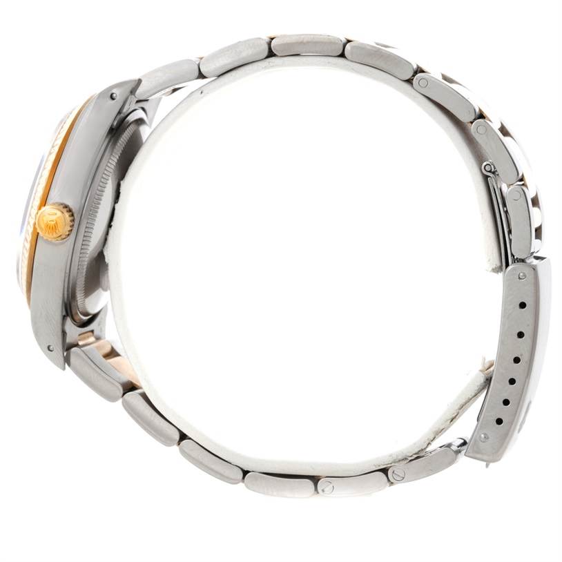 This side view of the Rolex Oyster Perpetual 14233 Men's Steel and Gold (two tone) Silver Dial 14233 Men's Steel and Gold (two tone) Silver Dial watch shows the case, crown, and bracelet.