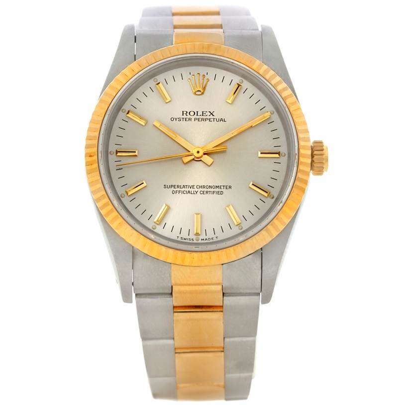 This Rolex Oyster Perpetual 14233 Men's Steel and Gold (two tone) Silver Dial 14233 Men's Steel and Gold (two tone) Silver Dial watch is shown from a front view, displaying the dial, hands, bezel, crown, and bracelet.