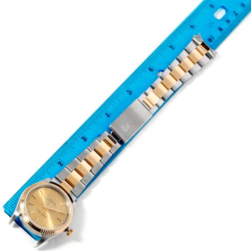 The image shows a top-down view of a Rolex Oyster Perpetual 14233 Men's Steel and Gold (two tone) Champagne Dial 14233 Men's Steel and Gold (two tone) Champagne Dial watch, including the dial, bracelet, and clasp beside a ruler.