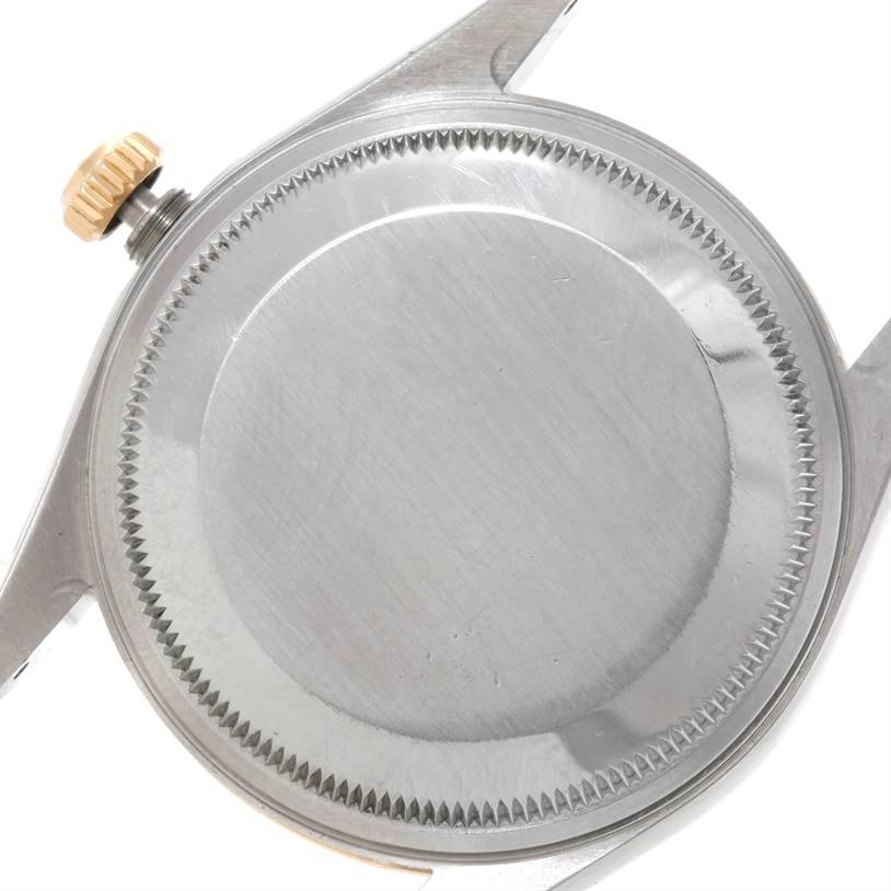 This image shows the back case and crown of a Rolex Oyster Perpetual 14233 Men's Steel and Gold (two tone) Champagne Dial 14233 Men's Steel and Gold (two tone) Champagne Dial watch.