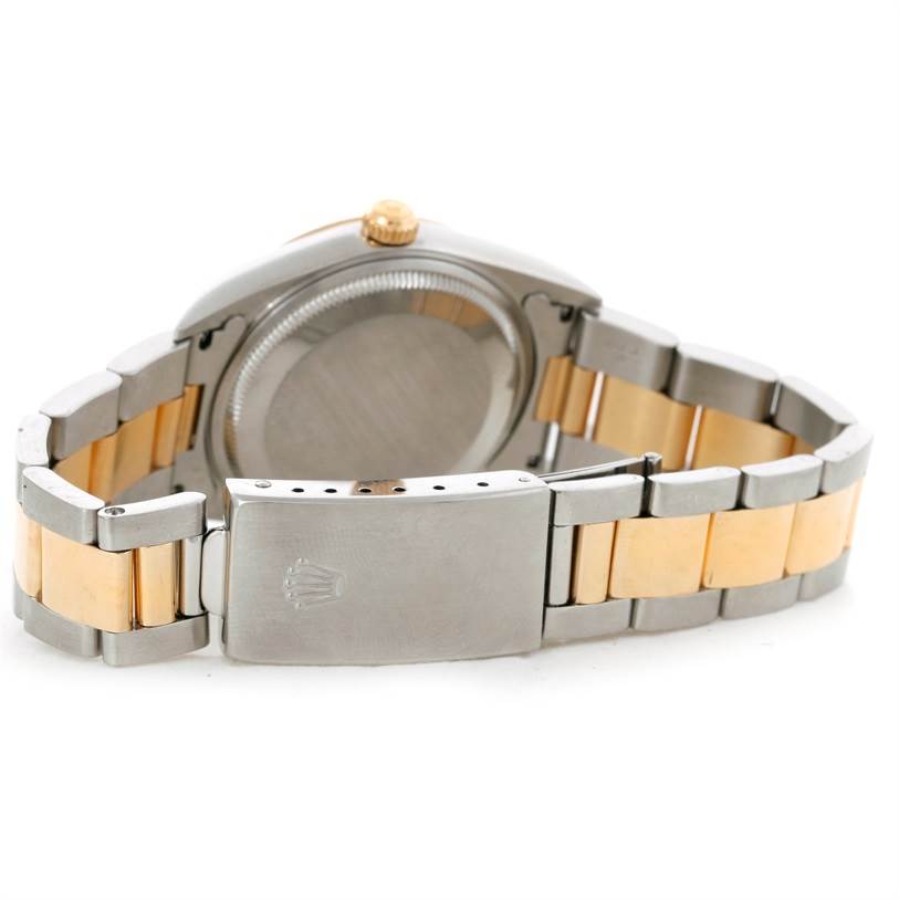 The image shows the back view of a Rolex Oyster Perpetual 14233 Men's Steel and Gold (two tone) Champagne Dial 14233 Men's Steel and Gold (two tone) Champagne Dial watch, highlighting its bracelet and clasp.