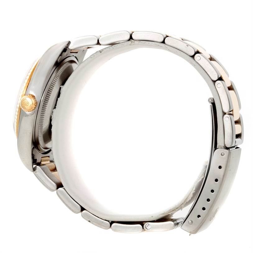 The Rolex Oyster Perpetual 14233 Men's Steel and Gold (two tone) Champagne Dial 14233 Men's Steel and Gold (two tone) Champagne Dial watch is shown from a side angle highlighting its crown and metal bracelet.