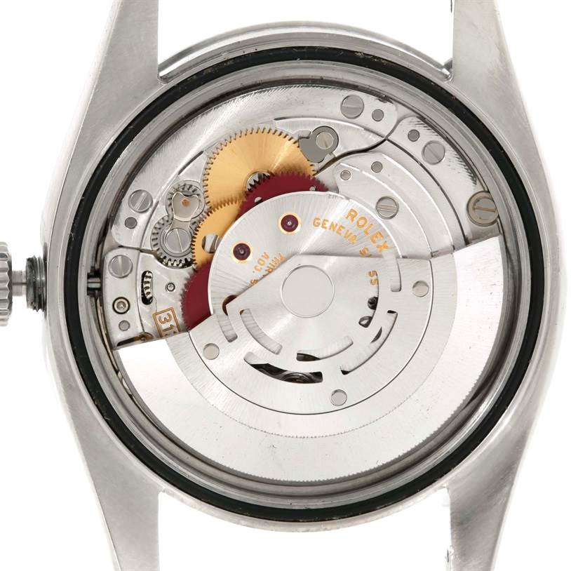 The image shows the internal mechanical movement of a Rolex Oyster Perpetual M831438 Men's Stainless Steel Black Dial M831438 Men's Stainless Steel Black Dial watch from a top-down angle.