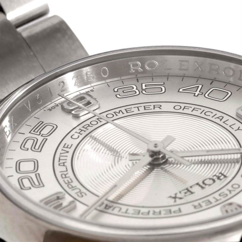 Close-up of the Rolex Oyster Perpetual 116000 Men's Stainless Steel Silver Dial 116000 Men's Stainless Steel Silver Dial watch showing the dial, part of the bracelet, and the bezel from an oblique angle.