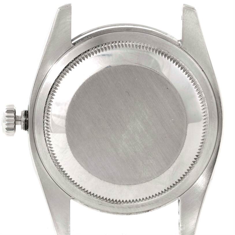 The image shows the back case and crown of the Rolex Oyster Perpetual 116000 Men's Stainless Steel Silver Dial 116000 Men's Stainless Steel Silver Dial watch from a rear angle.