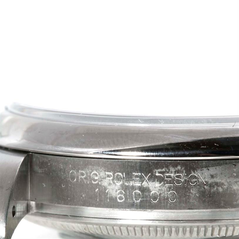 This image shows a close-up of the side of a Rolex Oyster Perpetual 116000 Men's Stainless Steel Silver Dial 116000 Men's Stainless Steel Silver Dial watch, focusing on the engraved model and design text.