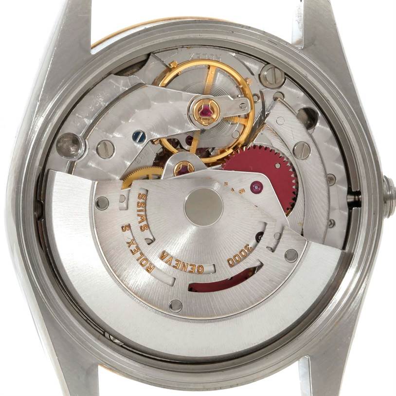 The image shows the inner mechanical movement of a Rolex Oyster Perpetual 14203 Men
s Steel and Gold (two tone) Grey Dial 14203 Men
s Steel and Gold (two tone) Grey Dial watch from a rear view.