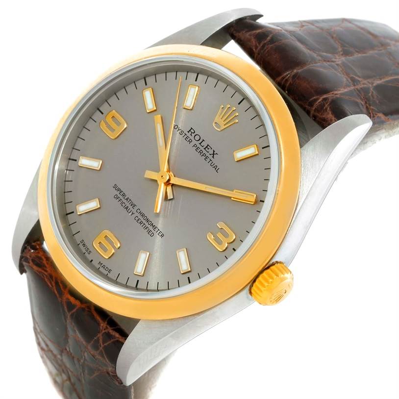 The image shows the front angle of a Rolex Oyster Perpetual 14203 Men
s Steel and Gold (two tone) Grey Dial 14203 Men
s Steel and Gold (two tone) Grey Dial watch, highlighting the dial, bezel, crown, and leather strap.