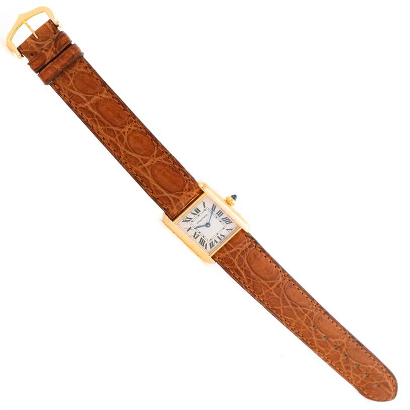 This image shows a full view of a Cartier Tank Louis W1529856 Women's Yellow Gold Silver Dial W1529856 Women's Yellow Gold Silver Dial model watch with a brown leather strap.