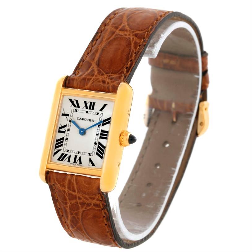 The Tank Louis model by Cartier is shown at a slight angle highlighting the face, crown, and leather strap.