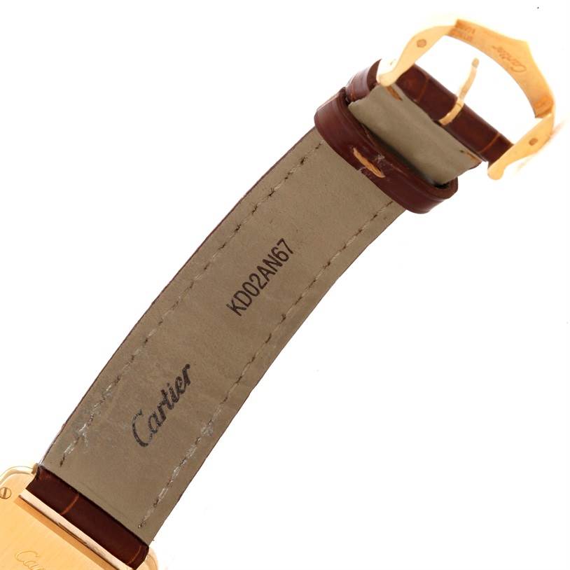 The image shows the underside of the strap and buckle of a Cartier Tank Louis W1529856 Women's Yellow Gold Silver Dial W1529856 Women's Yellow Gold Silver Dial watch from an oblique angle.