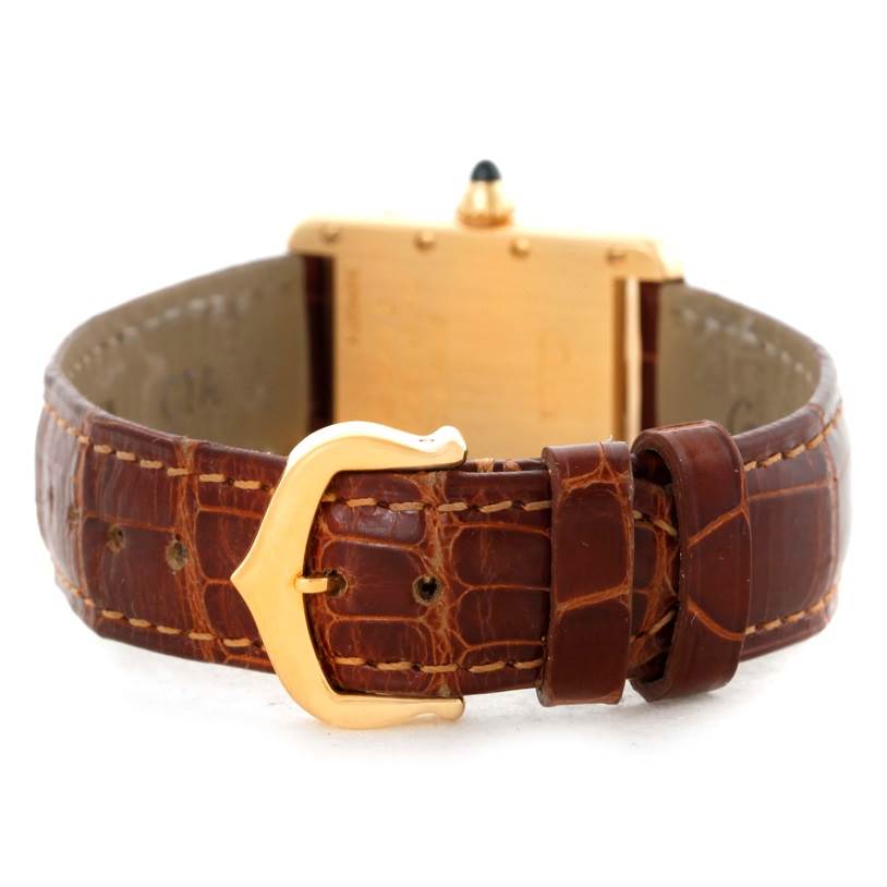 The image shows the back view of a Cartier Tank Louis W1529856 Women's Yellow Gold Silver Dial W1529856 Women's Yellow Gold Silver Dial watch focusing on the brown leather strap and gold buckle.