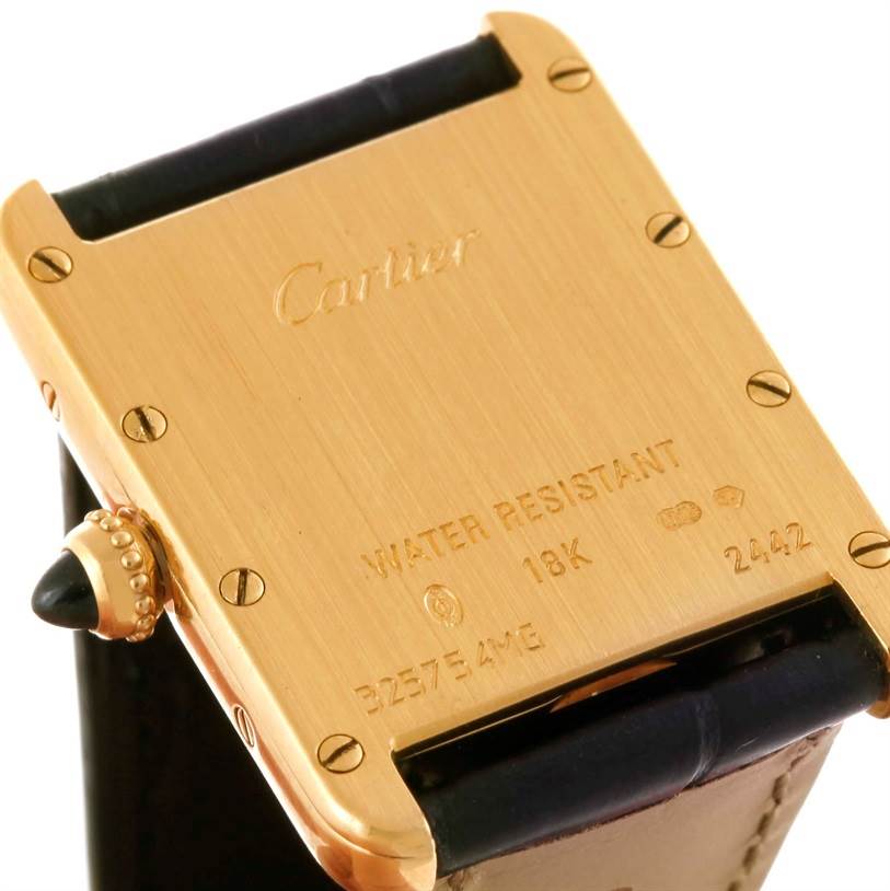 This image shows the back of a Cartier Tank Louis W1529856 Women's Yellow Gold Silver Dial W1529856 Women's Yellow Gold Silver Dial watch, highlighting its gold casing and engraving.