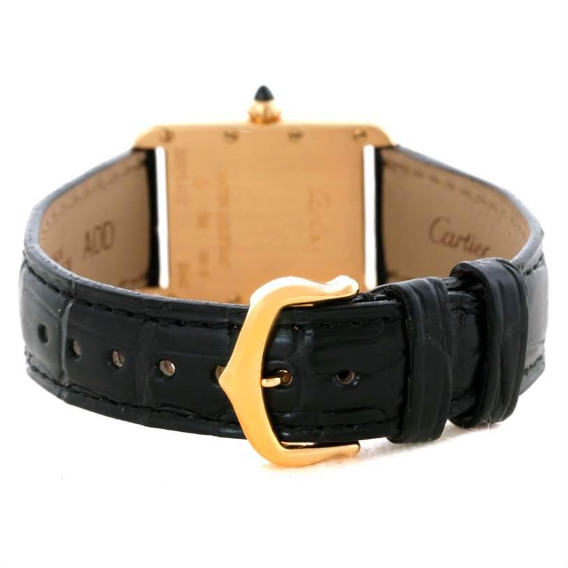 The image shows the back of a Cartier Tank Louis W1529856 Women's Yellow Gold Silver Dial W1529856 Women's Yellow Gold Silver Dial watch, focusing on the gold buckle and black leather strap.