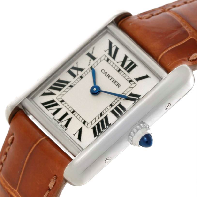 The image shows a close-up angle of the Cartier Tank Louis W154105 Women's White Gold Silver Dial W154105 Women's White Gold Silver Dial watch, highlighting the dial, blue hands, crown, and brown leather strap.