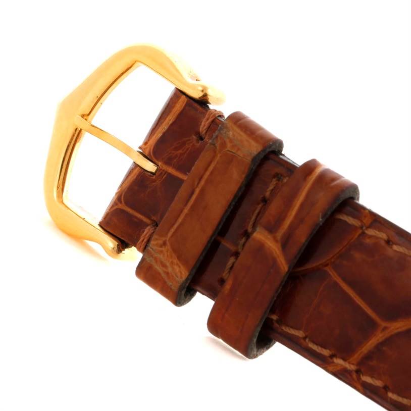 The image shows a close-up view of the buckle and strap of a Tank Louis Cartier watch.
