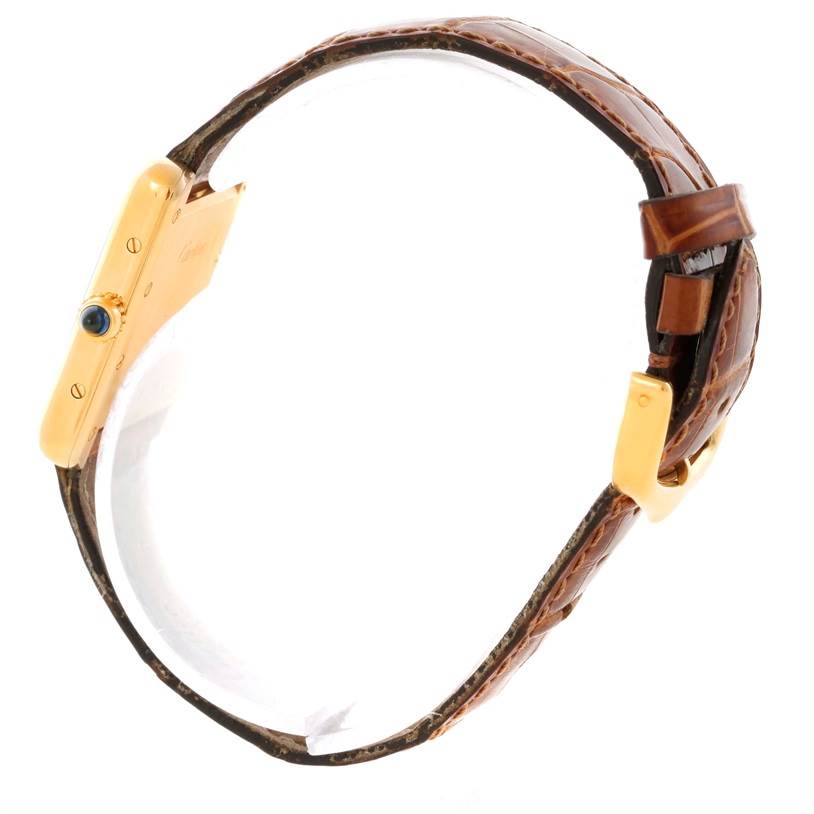 The image shows a side view of a Cartier Tank Louis W1529856 Women's Yellow Gold Silver Dial W1529856 Women's Yellow Gold Silver Dial watch, highlighting its gold case, crown, and brown leather strap.