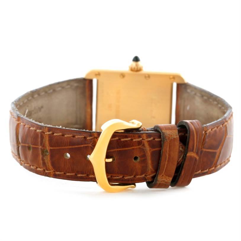 This image shows the back view of a Cartier Tank Louis W1529856 Women's Yellow Gold Silver Dial W1529856 Women's Yellow Gold Silver Dial watch, focusing on the brown leather strap and gold buckle.